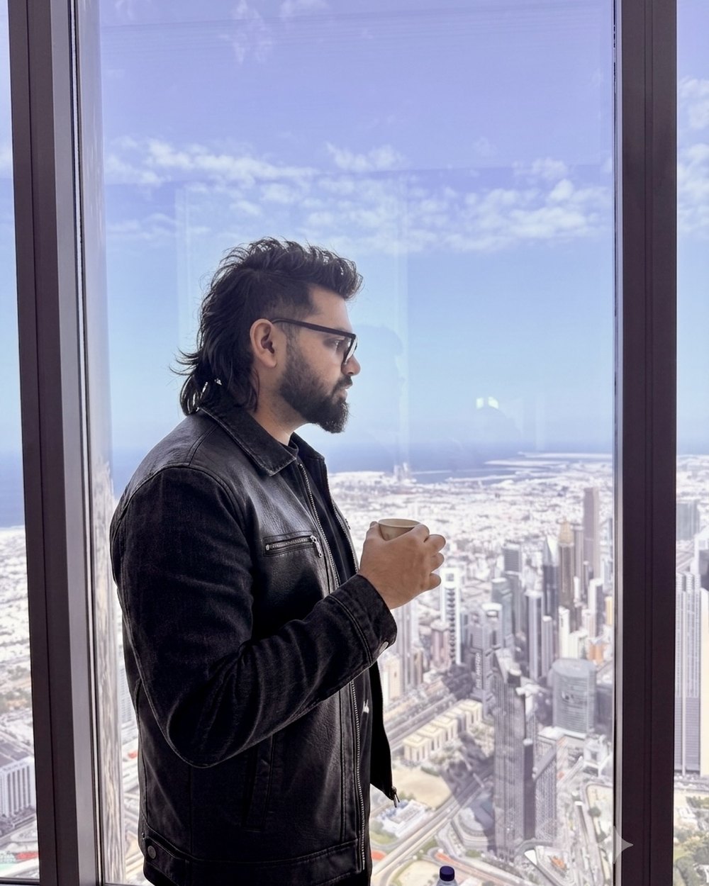 Mohammad Naveed at the top of the Burj Khalifa, looking out over Dubai